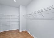 Thumbnail 66 of 77 - Walk-in closet with wire shelving systems at The Flats at West Glen Apartments, West Des Moines, IA 50266