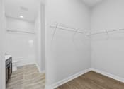 Thumbnail 30 of 52 - A white bathroom with a walk-in shower and a toilet.