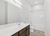 Thumbnail 18 of 52 - A white bathroom with a sink, toilet, and bathtub.