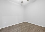 Thumbnail 29 of 52 - A room with a light brown floor and white walls.