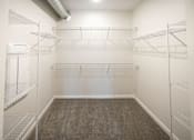 Thumbnail 11 of 40 - a spacious room with mirrored walls and empty closet space at Velocity Apartments, Des Moines, IA