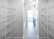 Thumbnail 38 of 40 - an empty closet in a room with white walls and white floors and a white door at Velocity Apartments, Des Moines, Iowa
