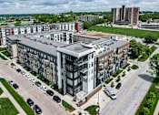 Thumbnail 37 of 40 - an aerial view of an apartment building in a city at Velocity Apartments, IA, 50309
