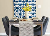 Thumbnail 5 of 15 - a dining room with a table and chairs and a blue and white tapestry at The Winhall of Williams Pointe Apartments, Waukee, IA, 50263