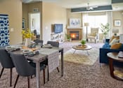 Thumbnail 10 of 15 - a living room with a table and chairs and a fireplace at The Winhall of Williams Pointe Apartments, IOWA, 50263