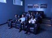 Thumbnail 12 of 15 - a group of people sitting in a living room watching a movie at The Winhall of Williams Pointe Apartments, Waukee, IA, 50263