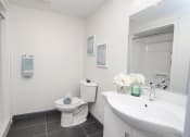 Thumbnail 11 of 13 - a bathroom with a sink toilet and a mirror
