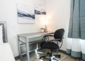 Thumbnail 10 of 13 - a desk with a chair in a room with a bed