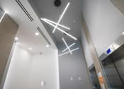 Thumbnail 4 of 13 - a view of the lobby of a building with lights on the ceiling