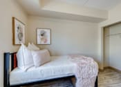 Thumbnail 25 of 33 - A bedroom with a bed, pillows, and pictures on the wall.