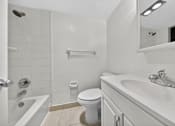 Thumbnail 21 of 21 - A white bathroom with a toilet, sink, and bathtub.