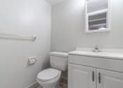 Thumbnail 15 of 21 - a white bathroom with a toilet and a sink