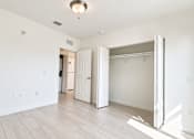 Thumbnail 33 of 48 - A room with a white door and a white closet.