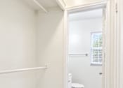 Thumbnail 13 of 19 - A white bathroom with a toilet and a marble floor.