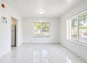 Thumbnail 14 of 19 - A white room with a marble floor and a window with blinds.