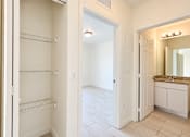 Thumbnail 27 of 48 - A white bathroom with a large mirror and a vanity.