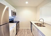 Thumbnail 1 of 15 - a kitchen with stainless steel appliances and a sink