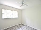 Thumbnail 10 of 15 - an empty bedroom with a ceiling fan and a window