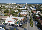 Thumbnail 10 of 21 - A view of a city with a large building in the foreground and a body of water in the background.