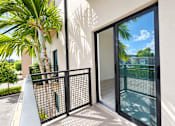 Thumbnail 18 of 48 - A black gate is in front of a white building.