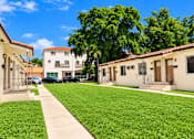 Thumbnail 6 of 19 - A sunny day at a residential area with houses and green lawns.