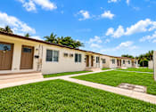 Thumbnail 5 of 19 - A row of houses with brown doors and windows.