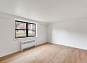 Thumbnail 22 of 49 - A room with a window and a radiator on the floor.