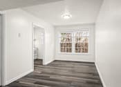 Thumbnail 21 of 31 - A room with a window and a wooden floor.