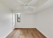 Thumbnail 20 of 49 - A room with a ceiling fan and a window.