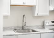Thumbnail 31 of 31 - A kitchen with a sink and a faucet.