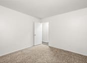Thumbnail 21 of 29 - A room with a carpeted floor and white walls.