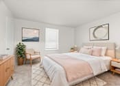 Thumbnail 6 of 29 - A bedroom with a large bed and a painting on the wall.
