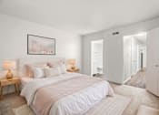Thumbnail 5 of 29 - A bedroom with a large bed and two lamps on side tables.