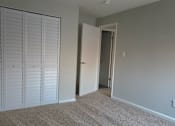Thumbnail 12 of 38 - A room with a carpeted floor and a white door.