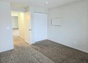 Thumbnail 23 of 38 - A room with a carpeted floor and a white door.