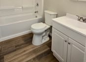 Thumbnail 24 of 38 - A white toilet sits in a bathroom next to a sink.