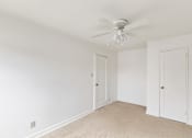 Thumbnail 23 of 49 - A room with a ceiling fan and two doors.
