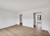 Thumbnail 19 of 49 - A room with wooden floors and white walls.
