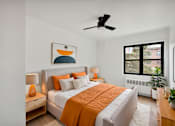 Thumbnail 14 of 49 - A bedroom with a bed, nightstands, and a ceiling fan.