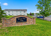 Thumbnail 29 of 30 - A sign that says Grand View Village is on a stone wall.