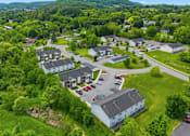 Thumbnail 22 of 30 - A bird's eye view of a residential area with houses and cars.