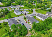 Thumbnail 24 of 30 - A bird's eye view of a residential area with houses and cars.