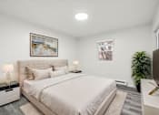 Thumbnail 5 of 16 - A bedroom with a large bed and a painting on the wall.