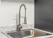 Thumbnail 13 of 29 - A modern kitchen sink with a chrome faucet.