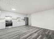 Thumbnail 2 of 16 - A kitchen with white cabinets and a wooden floor.