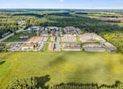 Thumbnail 64 of 65 - A large green field with a building complex in the middle.