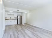 Thumbnail 11 of 26 - A kitchen with white cabinets and a stainless steel refrigerator.