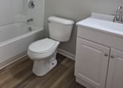 Thumbnail 38 of 38 - A white toilet sits next to a sink in a small bathroom.