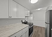 Thumbnail 7 of 29 - A kitchen with white cabinets and a black stove top oven.