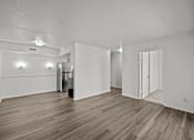 Thumbnail 12 of 29 - A room with wood flooring and white walls.